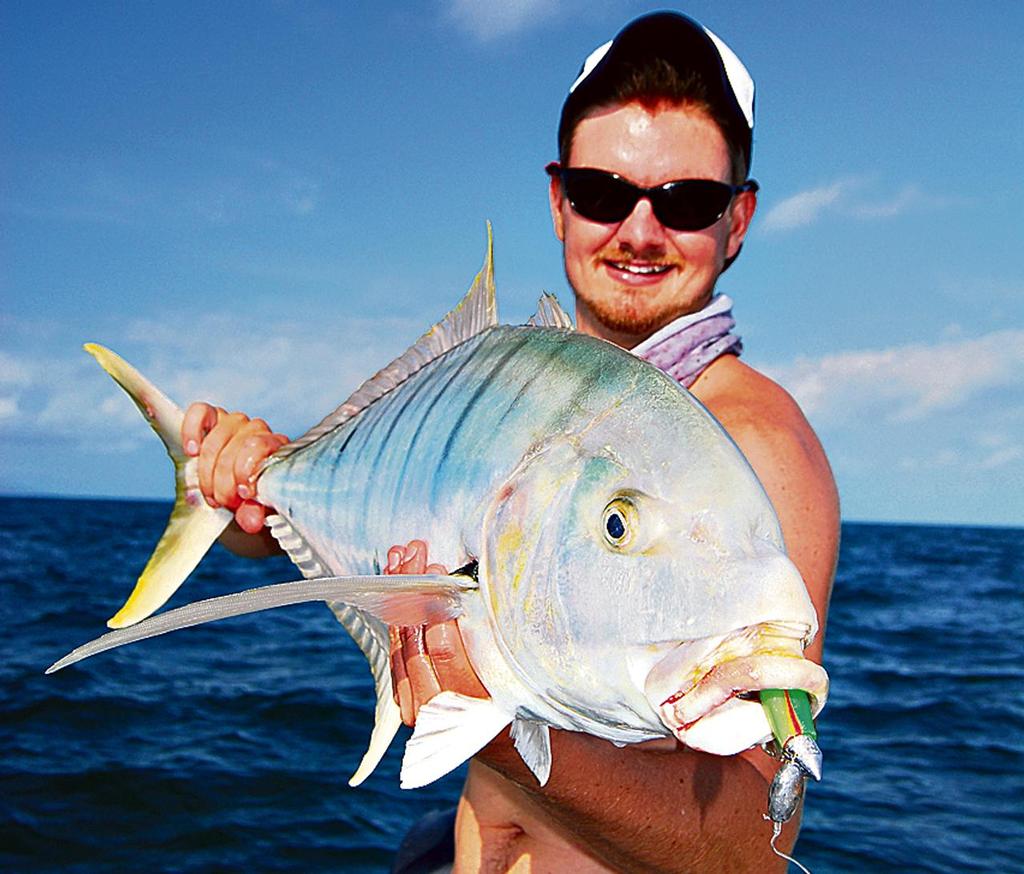 Lee with a solid golden trevally jigged up on  a Nuclear Chicken Gulp Plastic and customized jighead. © Lee Brake